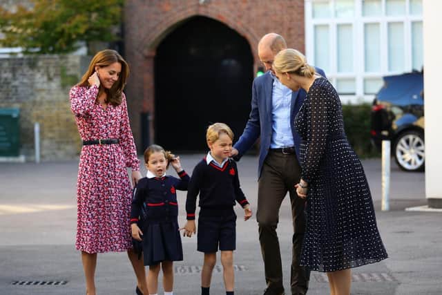 Helen Haslem (right), head of the lower school greets Princess Charlotte as she arrives for her first day of school, with her brother Prince George and her parents the Duke and Duchess of Cambridge, at Thomas's Battersea in London.