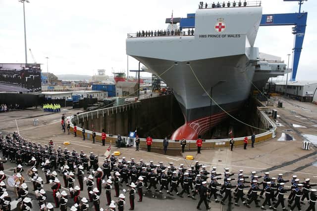 The Royal Marines band and members of the Royal Navy during the naming ceremony of aircraft carrier HMS Prince of Wales at the Royal Dockyard in Rosyth in 2017 Picture: Andrew Milligan/PA Wire