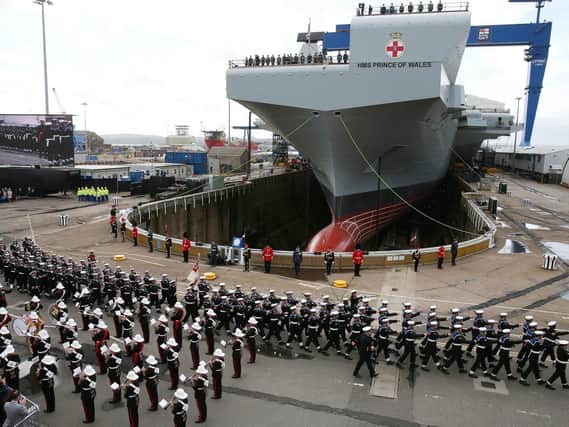 The Royal Marines band and members of the Royal Navy during the naming ceremony of aircraft carrier HMS Prince of Wales at the Royal Dockyard in Rosyth in 2017 Picture: Andrew Milligan/PA Wire