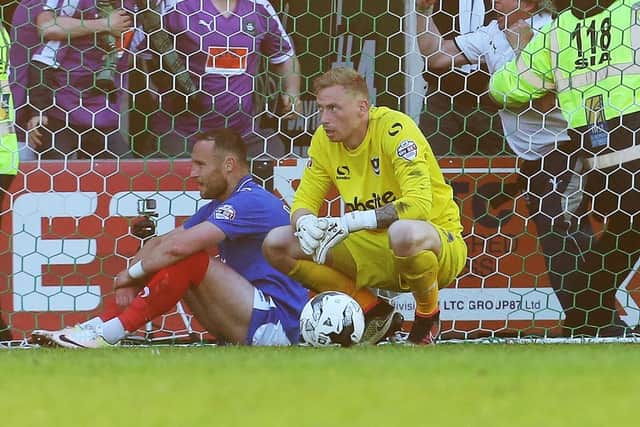 Ryan Allsop dejected after Plymouth's Peter Hartley dumped Pompey out of the League Two play-offs in 2016. Picture: Joe Pepler