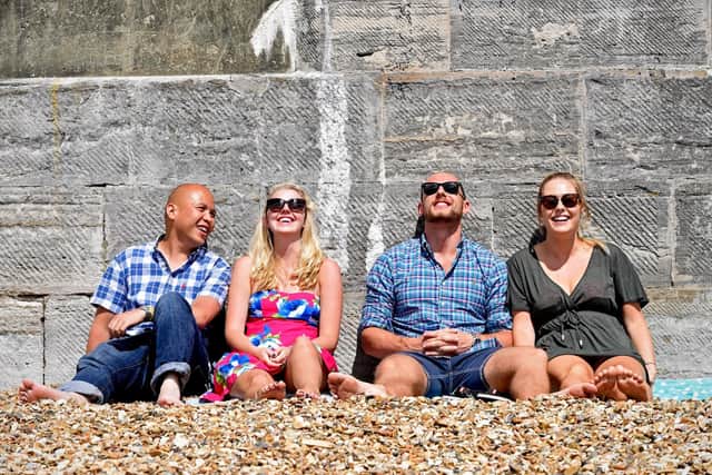 A group of friends relax in the sun at the Hot Walls in Southsea, Portsmouth. Picture: Solent News & Photo Agency