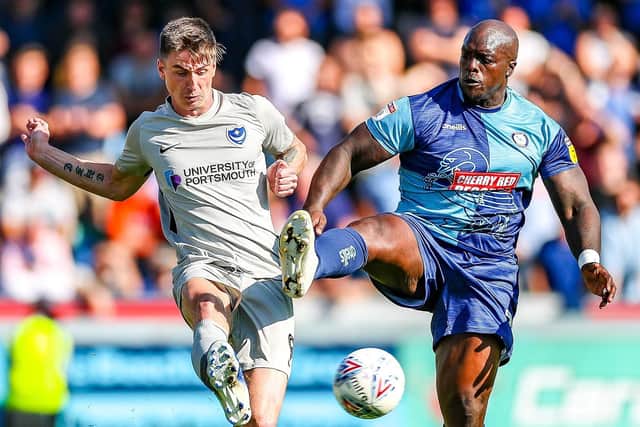 Oli Hawkins, seen here tussling with Adebayo Akinfenwa, impressed Kenny Jackett on his central-defensive return against Wycombe. Picture: Nigel Keene