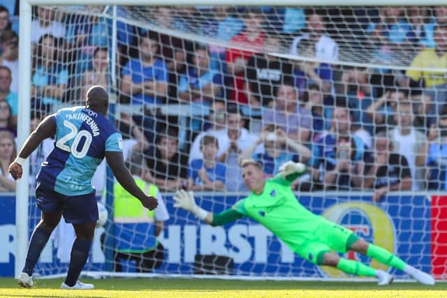 Adebayo Akinfenwa scores from the penalty spot against Pompey   Picture: Nigel Keene
