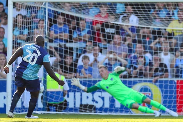 Adebayo Akinfenwa scores from the penalty spot against Pompey   Picture: Nigel Keene