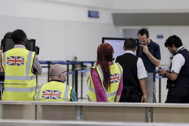 British government officials wait for stranded British passengers at the Cancun airport in Mexico, Monday, Sept. 23, 2019. British tour company Thomas Cook collapsed early Monday after failing to secure emergency funding, leaving tens of thousands of vacationers stranded abroad. (AP Photo/Victor Ruiz)