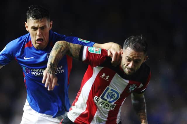 Danny Ings is placed under pressure by James Bolton