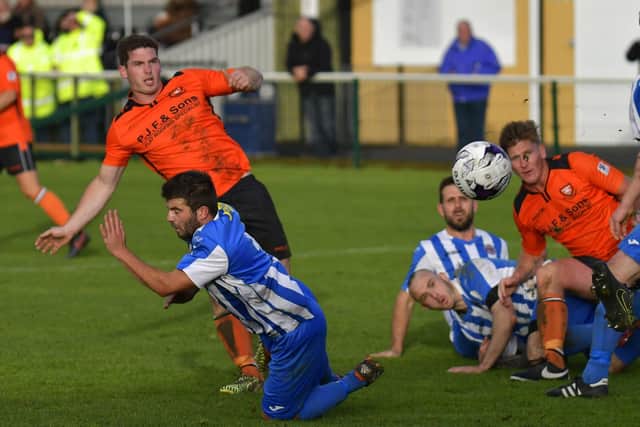 Garry Moody (orange, left) was on target for Fareham at Lymington