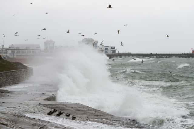 Waves crashing on the seafront near to the South Parade pier in Southsea. Picture: Andrew Matthews/PA Wire