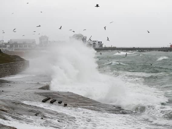 Waves crashing on the seafront near to the South Parade pier in Southsea. Picture: Andrew Matthews/PA Wire