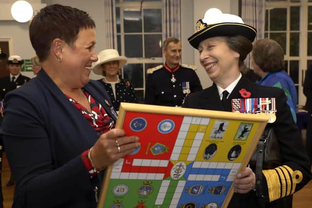 Her Royal Highness, The Princess Royal, being presented an uckers board by former Warrant Officer Alison Gott. Picture: LPhot Barry Swainsbury