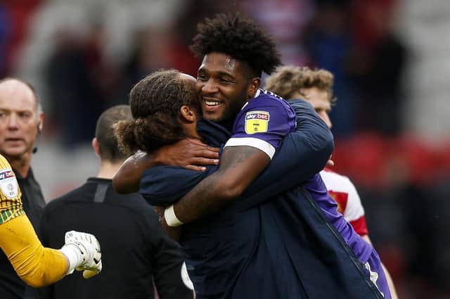 Ellis Harrison celebrates Pompey's win with Marcus Harness. Picture: Daniel Chesterton/PinPep