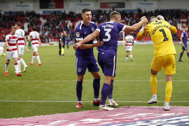 From left: James Bolton, Lee Brown and Craig MacGillivray celebrate Pompey's victory. Picture: Daniel Chesterton/PinPep)