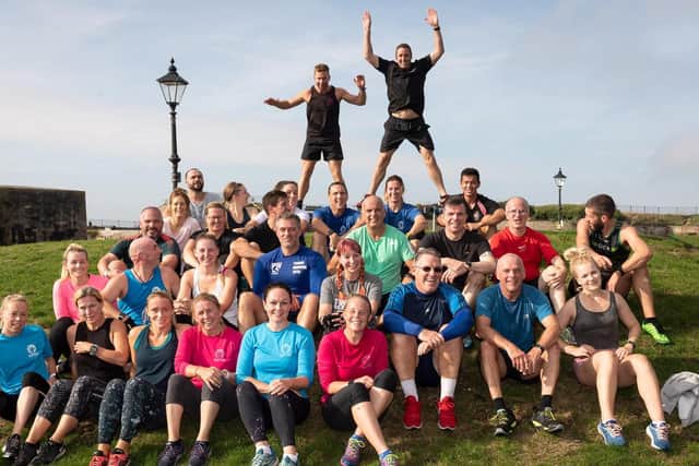 Tristram Murdoch and Gavin Brett of Portsmouth Outdoor Fitness perform star jumps behind all those who attended the session. Picture: Keith Woodland (051019-54)