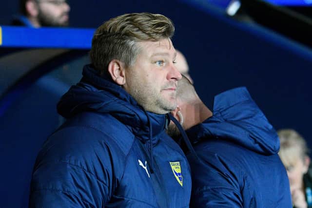 Oxford manager Karl Robinson watches on