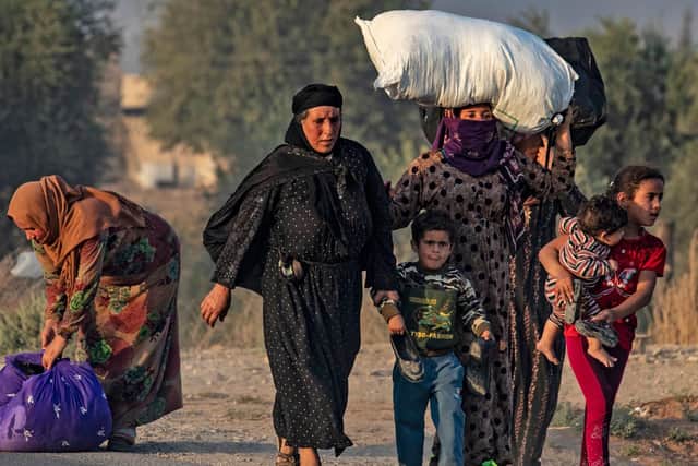 Syrian Arab and Kurdish civilians flee amid Turkish bombardment on Syria's northeastern town of Ras al-Ain in the Hasakeh province along the Turkish border on October 9, 2019.  Photo: Delil SouleimanAFP via Getty Images