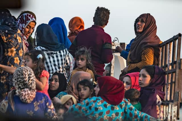 Syrian Arab and Kurdish civilians flee amid Turkish bombardment on Syria's northeastern town of Ras al-Ain in the Hasakeh province along the Turkish border Photo: Delil Souleiman/AFP via Getty Images