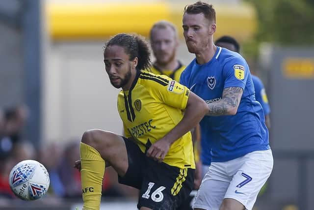 Marcus Harness in action against Tom Naylor during Pompey's clash against Burton last season. Picture: Daniel Chesterton/phcimages.com
