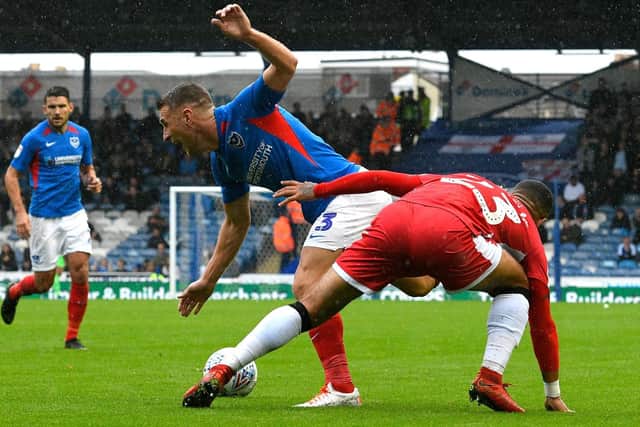 Lee Brown is fouled by Gillingham's Alex Jakubiak