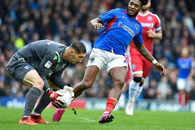 Ellis Harrison challenges Gills keeper Jack Bonham    Picture: Graham Hunt