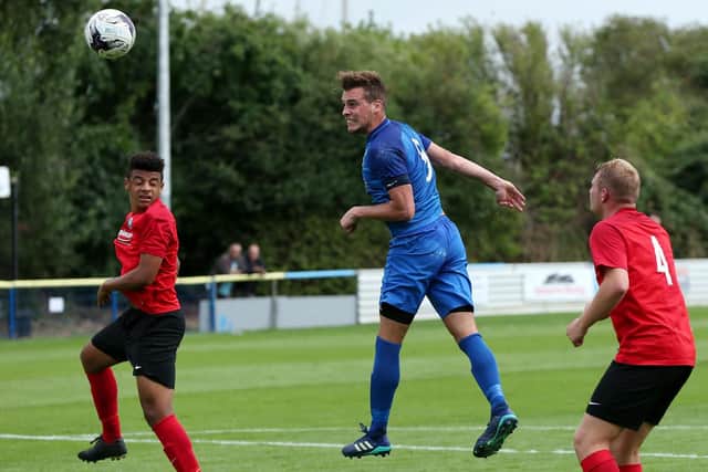 Jason Parish (blue) was AFC Portchester's Vase hero at Cullompton
