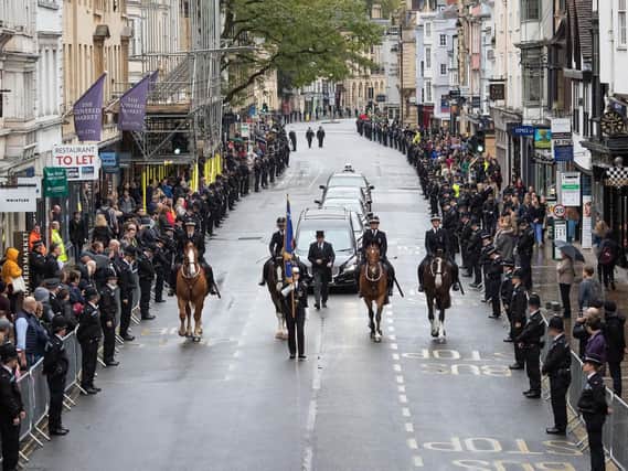Members of the public line the High Street in Oxford to pay their respects as the funeral cortege for PC Andrew Harper.