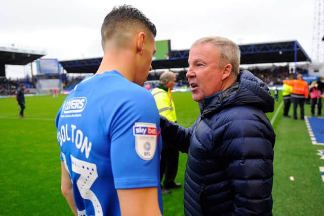 Pompey boss Kenny Jackett talks to James Bolton at the final whistle on Saturday Picture: Graham Hunt