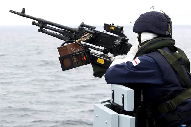 Sailors get their eye in during small arms firing at sea.