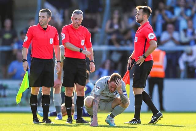 Pompey captain Tom Naylor (4) after defeat at Wycombe    Picture: Nigel Keene