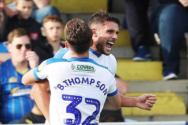 Gareth Evans and Ben Thompson celebrate then-League One leaders Pompey scoring at AFC Wimbledon 12 months ago. Picture: Joe Pepler/Digital South