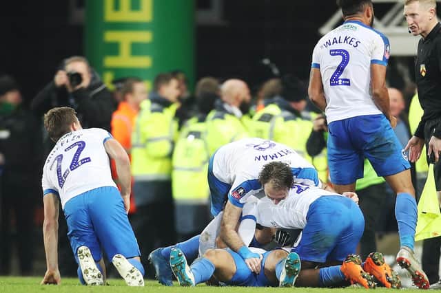 Pompey's players mob Andre Green following his last-gasp FA Cup winner at Norwich last season. Picture: PinPep Media/Joe Pepler