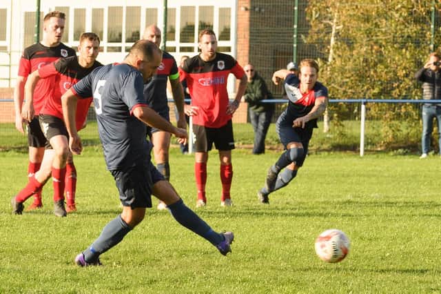 Adam Fisher about to see his penalty saved by Bush Hill keeper Niall Devereaux