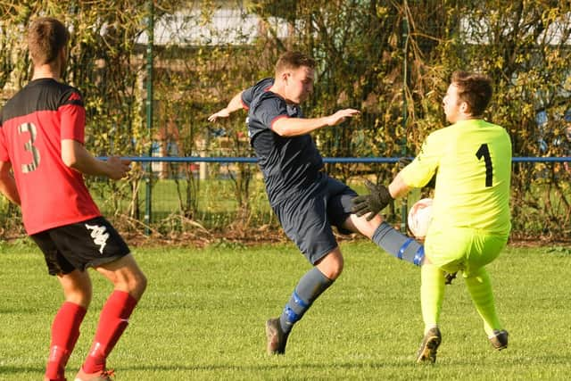 Bush keeper Niall Devereaux blocks a Jimmy Hird shot