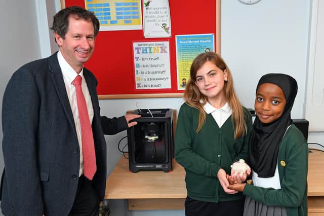 (left to right) Chris Heal of EMCO Education with Eva Osborne (10) and Mesbah Hussein (10) with their 3D Printer prototype, 'Meva'