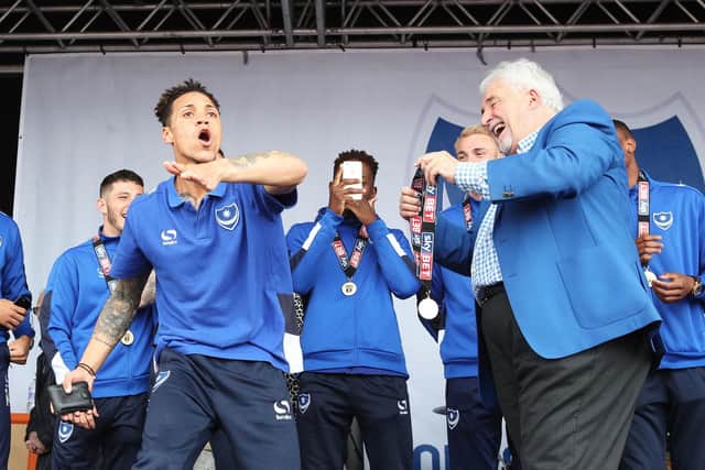 Kyle Bennett takes former Pompey chairman Iain McInnes' wallet during the League Two title celebrations. Picture: Joe Pepler