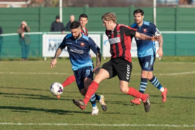 Fareham's Simon Woods in El Creekio derby action against Portchester pair Marco Gambelardini and Steven Ramsey last February.
