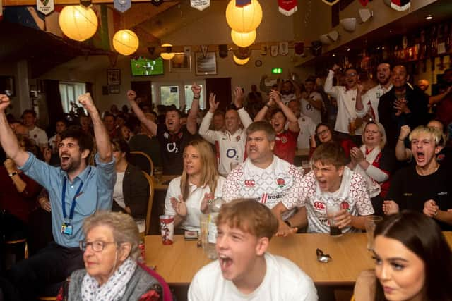 News reporter Tom Cotterill, far left, celebrated with fans at Portsmouth Rugby Club as England score a penalty.  Picture: Vernon Nash (021119-010)