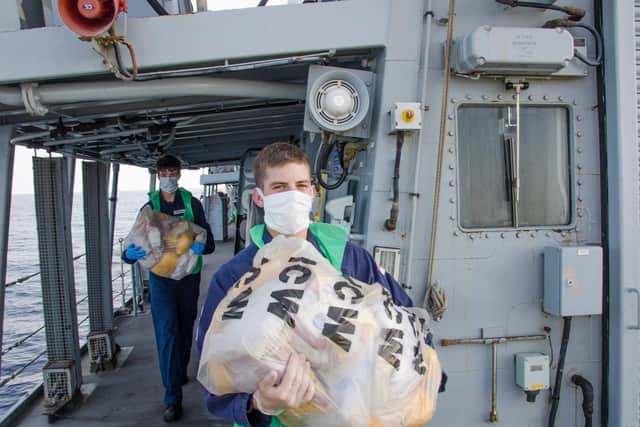 Members of Montrose's ship's company pictured carrying drugs seized from a fishing vessel. Photo: Royal Navy/Chris Daly