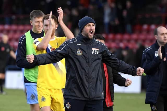 YORK, ENGLAND - NOVEMBER 10: Phil Parkinson, manager of Altrincham celebrates with his staff and players after his sides's FA Cup first-round win at York City. Picture: George Wood/Getty Images