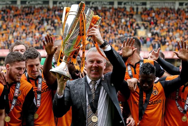 Kenny Jackett lifts League One trophy after leading Wolves to glory. Picture: Scott Heavey/Getty Images