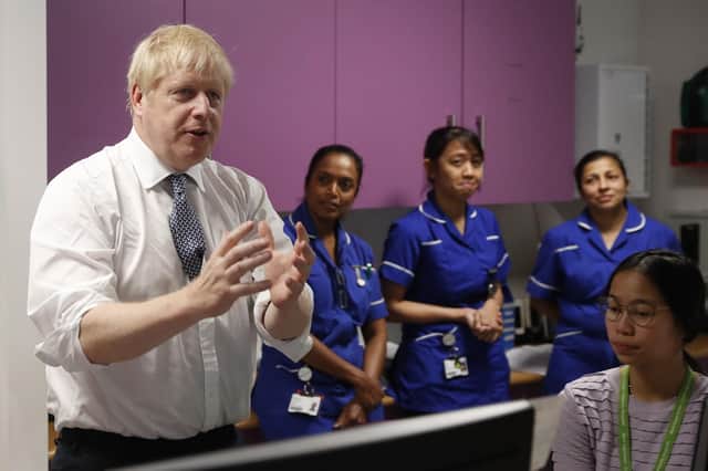 Prime Minister Boris Johnson speaks to nurses during a visit to the National Institute for Health Research at the Cambridge Clinical Research Facility, in Addenbrooke's Hospital in Cambridge. PA Photo. Pic: Alastair Grant/PA Wire