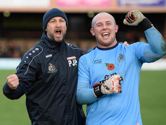 Altrincham boss Phil Parkinson celebrates with keeper Anthony Thompson following the Robins' FA Cup victory at York  Picture: George Wood/Getty Images