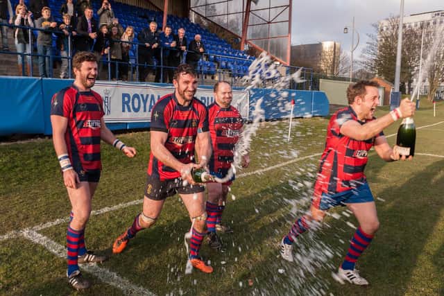 US Portsmouth players spray champagne after winning the Hampshire title in 2014/15 with a 100 per cent record