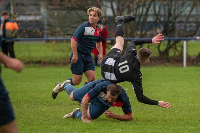 Hayling's George Rough is upended by Paulsgrove's Jake Warlow