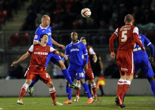 ORIENT_12/3/13Johnny Ertl heads above Lloyd James. Portsmouth FC V Leyton Orient at Leyton Orient. Picture: Allan Hutchings