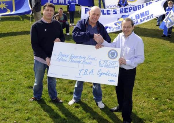 The Pompey Supporters Trusts Mick Williams, right, accepts a cheque for Â£16,000 from internet syndicate duo Steve McLenaghan and Steve Pearse