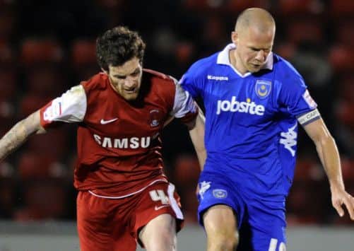 Johnny Ertl battles for the ball with Leyton Orients Romain Vincelot