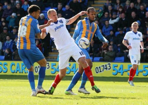 Pompey skipper Johnny Ertl battles for the ball at Shrewsbury Picture: Joe Pepler