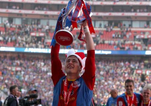 Joel Ward holds aloft the Championship play-off final trophy after Crystal Palaces 1-0 victory over Watford at Wembley