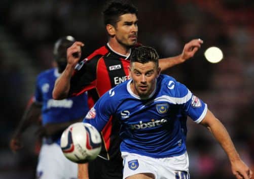 Pompey new-boy Tom Craddock gets the better of former Blues player Richard Hughes Picture: Joe Pepler