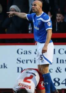 Stevenages Filipe Morais recovers with his face in the ground as Gavin Mahon stands over him after the clash which saw the Pompey midfielder sent off in the second half Picture: Joe Pepler